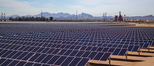 Midday view of solar panels with mountains in the distance