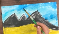 Hand painting a mountain scene