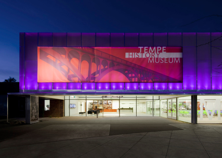 Front facade of the Tempe History Museum lit up at night