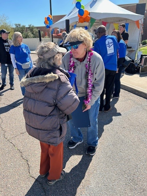 Councilmember Adams speaks with a member of the public at the Tempe Care Fair