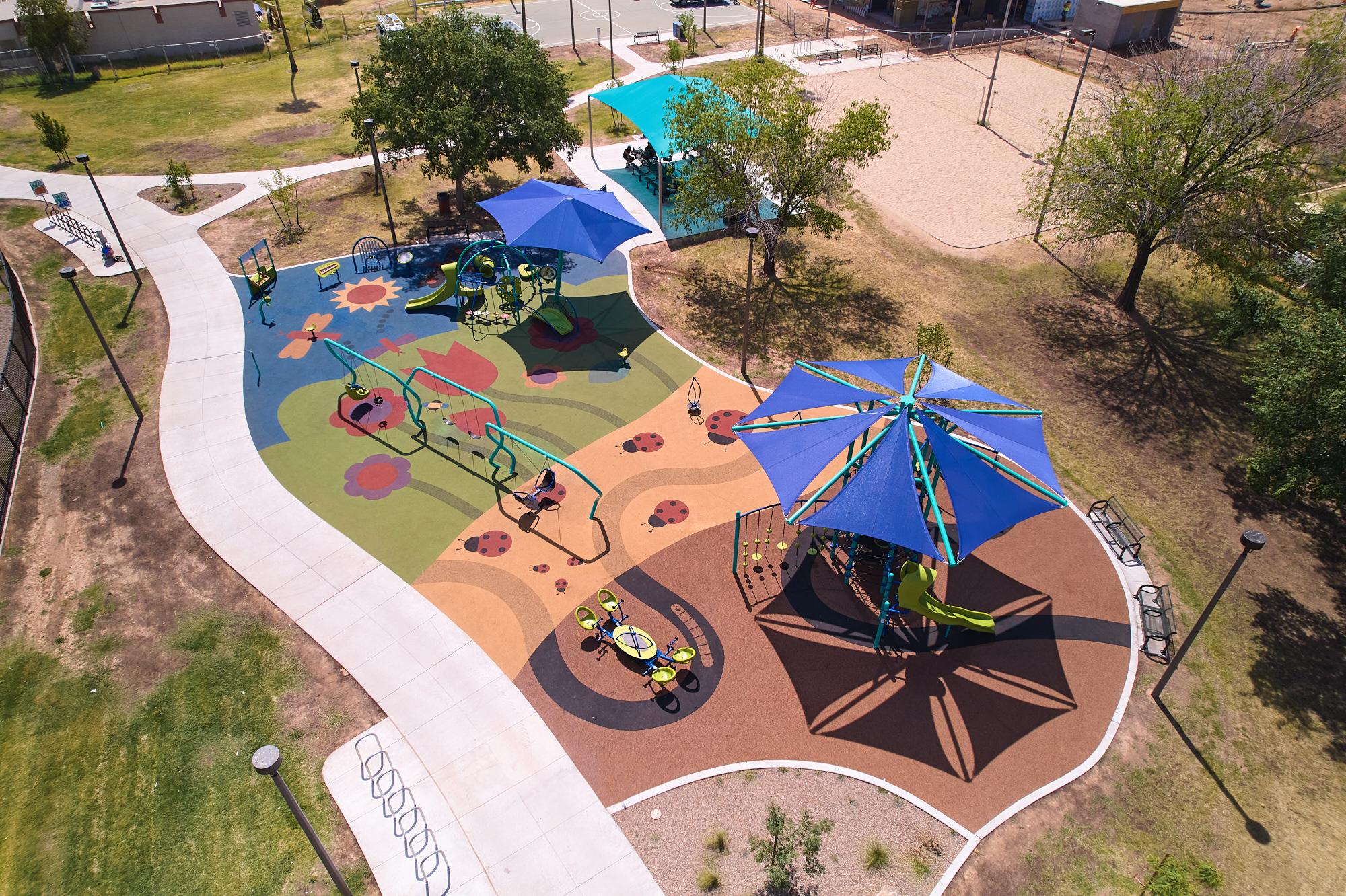 Aerial image of a playground with colorful design on the ground.