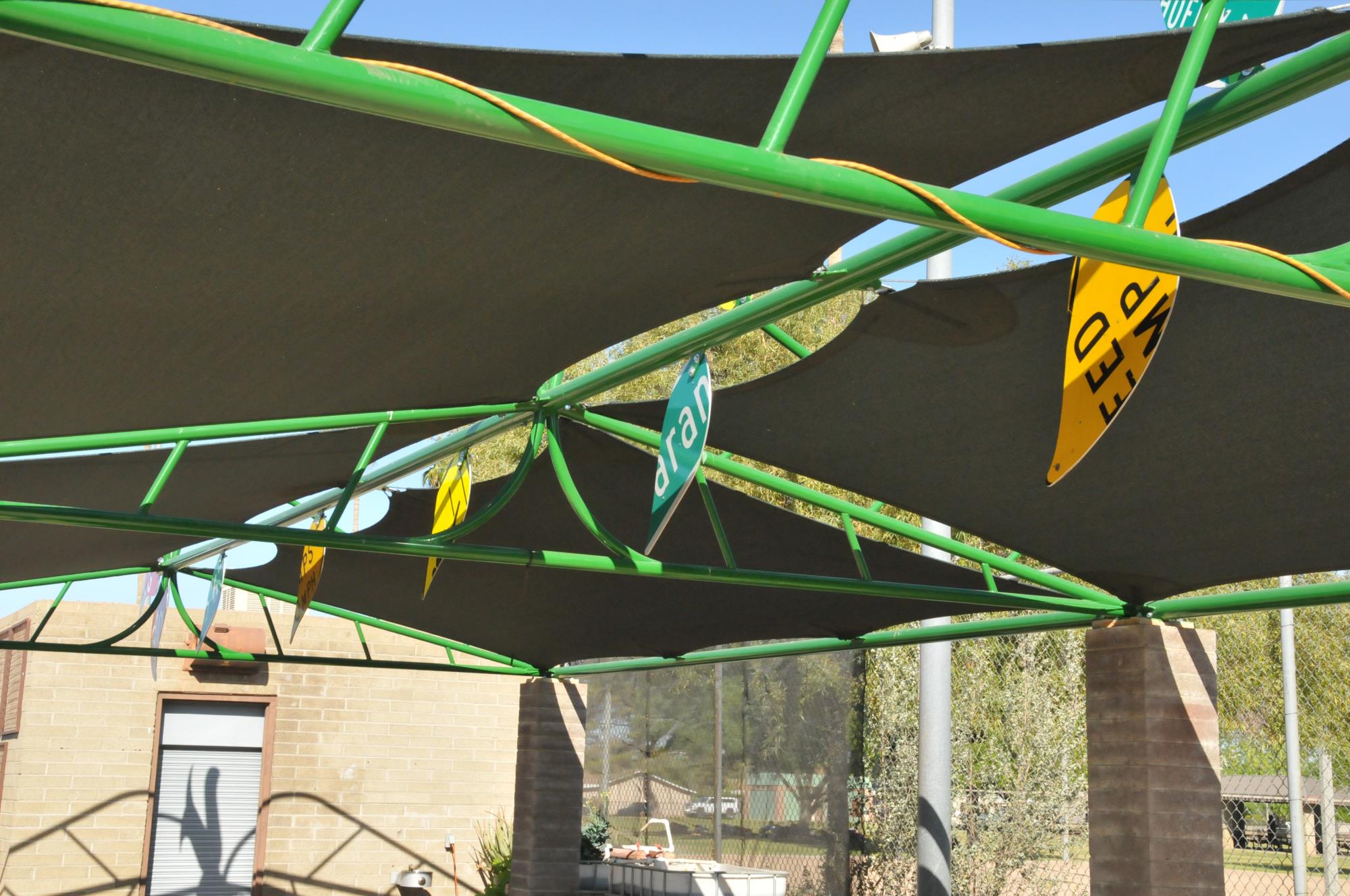 Image of green canopy with leaves cut from old road signs.